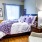 a bedroom with a bed and a chair