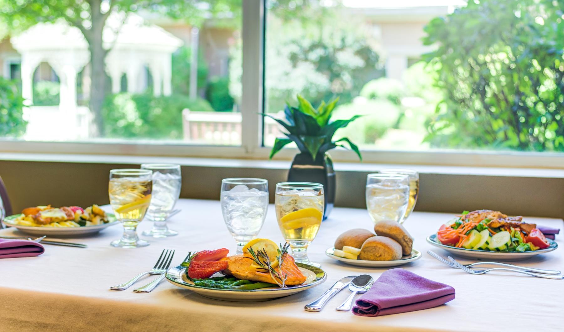 Bustling community with plenty of dining choices a table with plates of food and glasses of wine