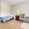 a bedroom with a bed and a chair
