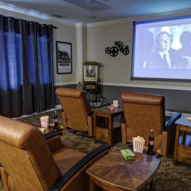Quick access to state-of-the-art amenities a living room with a large screen